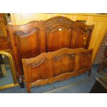 AN ANTIQUE OAK CARVED FRENCH BED, with modern base and irons, W 140 cm