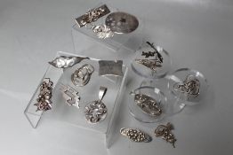 A COLLECTION OF SILVER AND WHITE METAL PENDANTS AND BROOCHES, comprising mainly hand crafted