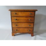 AN APPRENTICE WOODEN CHEST OF FOUR DRAWERS, W 33.5 cm, H 37 cm, D 17 cm