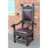 AN ANTIQUE OAK BARONIAL STYLE ARMCHAIR, carved heraldic and mask detail throughout, the arms