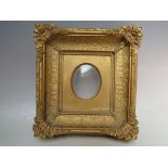 A 19TH CENTURY DECORATIVE GOLD PORTRAIT MINIATURE FRAME, with corner embellishments with gold