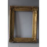 A 19TH CENTURY DECORATIVE GOLD FRAME, with corner embellishments, frame W 7 cm, rebate 44 x 31 cm