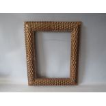 A 20TH CENTURY CARVED WOODEN DECORATIVE FRAME, frame W 7 cm, rebate 40 x 30 cm