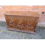 AN EARLY 20TH CENTURY MULE CHEST, with typical hinged lid above a triple panel front, each panel