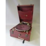 A NATIONAL BAND PORTABLE GRAMOPHONE, having a red covering with black grain effect finish, chrome n