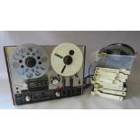 AN AKAI 4000DS THREE HEAD REEL TO REEL TAPE RECORDER, having a wooden outer case, brushed aluminium