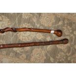 A VINTAGE HARDWOOD SPIRAL TWIST TAPERING WALKING CANE, L 82 cm, together with a vintage Oriental