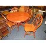 A MODERN CIRCULAR TABLE AND FOUR CHAIRS