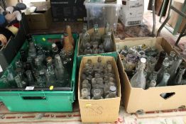 A LARGE QUANTITY OF VINTAGE GLASS BOTTLES TO INCLUDE LOCAL INTEREST EXAMPLES