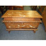 AN EASTERN HARDWOOD HINGED COFFER - INLAID WITH ELEPHANTS, FLORAL DETAIL AND RAISED ON ELEPHANT FEET