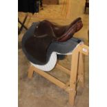 A HORSE RIDING SADDLE PLUS STAND