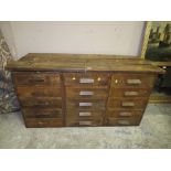 A VINTAGE BANK OF THREE DRAWERS WITH A LATER PLANK TOP H-76 CM W-149 CM