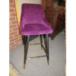 A MODERN PURPLE UPHOLSTERED STOOL