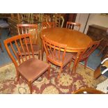 A RETRO TEAK G-PLAN EXTENDING DINING TABLE WITH SIX CHAIRS