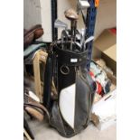 A GOLF BAG PLUS A SELECTION OF CLUBS TO INCLUDE DUNLOP AND WILSON