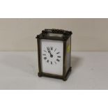 A VINTAGE BRASS AND GLASS CARRIAGE CLOCK
