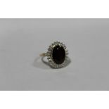 A HALLMARKED 9 CARAT GOLD GARNET AND WHITE STONE DRESS RING SIZE - P APPROX WEIGHT - 4.9G