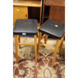 A PAIR OF RETRO STOOLS WITH BLACK VINYL SEATS