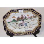 AN OCTAGONAL HAND PAINTED ORIENTAL STYLE CERAMIC PLATTER DECORATED WITH A HUNTSMAN ON HORSEBACK IN A