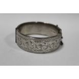 A HALLMARKED SILVER ENGRAVED BANGLE APPROX WEIGHT - 58.6G