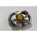 A SCOTTISH STYLE WHITE METAL BROOCH SET WITH AGATE AND CITRINE