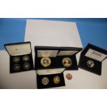 A CASED QEII SET OF COLOURED COINS to include 2017 four mini gold coin collection (9ct), 2 oz silver