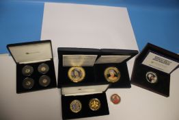 A CASED QEII SET OF COLOURED COINS to include 2017 four mini gold coin collection (9ct), 2 oz silver