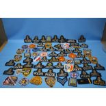 A QUANTITY OF CLOTH POLICE BADGES AND PATCHES to include British, French and American types