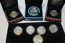 TWO CASED 2012 OLYMPICS SILVER PROOF £5 CROWNS, a cased silver 2012 Paralympics £5 crown and five