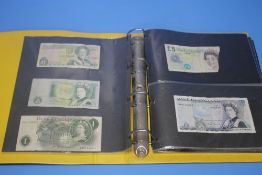 AN ALBUM OF WORLD BANK NOTES to include two BOE £5 notes, a US $20 bill etc.