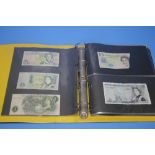 AN ALBUM OF WORLD BANK NOTES to include two BOE £5 notes, a US $20 bill etc.