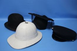 A MILITARY TYPE WHITE PITH HELMET, a military peaked cap, a 'Christys' bowler hat and an academic