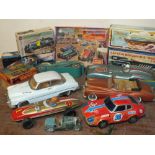 A COLLECTION OF MOSTLY VINTAGE REPRODUCTION TIN PLATE MODEL CARS, together with a boxed mechanical