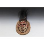 A TRIBAL MASK, with feather headdress, H 56 cm approx inc feathers Condition Report:cracked