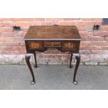 A LATE 19TH / EARLY 20TH CENTURY WALNUT CROSS BANDED LOWBOY, having three short frieze drawers,
