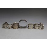 A COLLECTION OF EIGHT HALLMARKED SILVER NAPKIN RINGS, to include an extra wide example, various