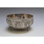 A SUB CONTINENTAL SILVER BOWL, decorated with nine religious deity style panels, mark to back,