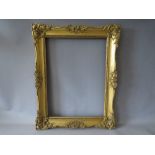 A 19TH CENTURY GILT SWEPT FRAME, frame W 7 cm, inner rebate 49 x 36 cm, outer rebate 54 x 41.5 cm