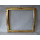 A 19TH CENTURY DECORATIVE GOLD WATERCOLOUR FRAME, with integral gold slip (some damages), frame W