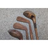 A LARGE QUANTITY OF VINTAGE WOODEN HANDLED GOLF CLUBS, some marked C H Clay, together with a