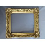 A 19TH CENTURY DECORATIVE GILT FRAME WITH LARGE CORNER EMBELLISHMENTS, frame W 12 cm, rebate 68 x