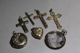 A SELECTION OF MAINLY 9CT GOLD PENDANTS, to include four crosses and two lockets, one of the lockets