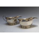 A MATCHED PAIR OF HALLMARKED SILVER SAUCE BOATS, one by Adie Bros - Birmingham 1925, the other by