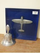 AN RAF BENEVOLENT FUND HAND BELL, together with a pewter model aircraft in blue / clear lucite block