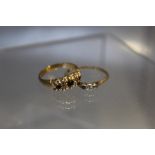 TWO 18CT GOLD LADIES GEMSET RINGS, the three stone ring missing one stone, the five stone gemset