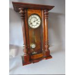 A LATE NINETEENTH CENTURY WALNUT VIENNA WALLCLOCK, with half turned pilasters to the case, H 66