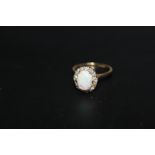 AN 18CT GOLD OPAL AND DIAMOND CLUSTER RING, the oval opal measuring an approx 10 mm x 6 mm,