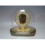 A BATTERY OPERATED KEININGER IMPULSE CLOCK, under glass dome, H 22 cm