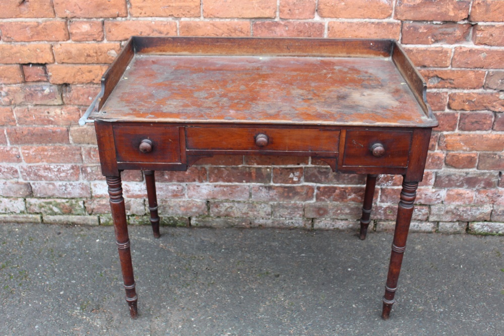 A 19TH CENTURY MAHOGANY TRAY TOP WASHSTAND, having three frieze drawers, raised on turned