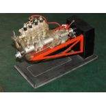 A VINTAGE CUT AWAY MODEL OF A FOUR CYLINDER ENGINE BY GERCHA, 20 x 10 x 14 cm